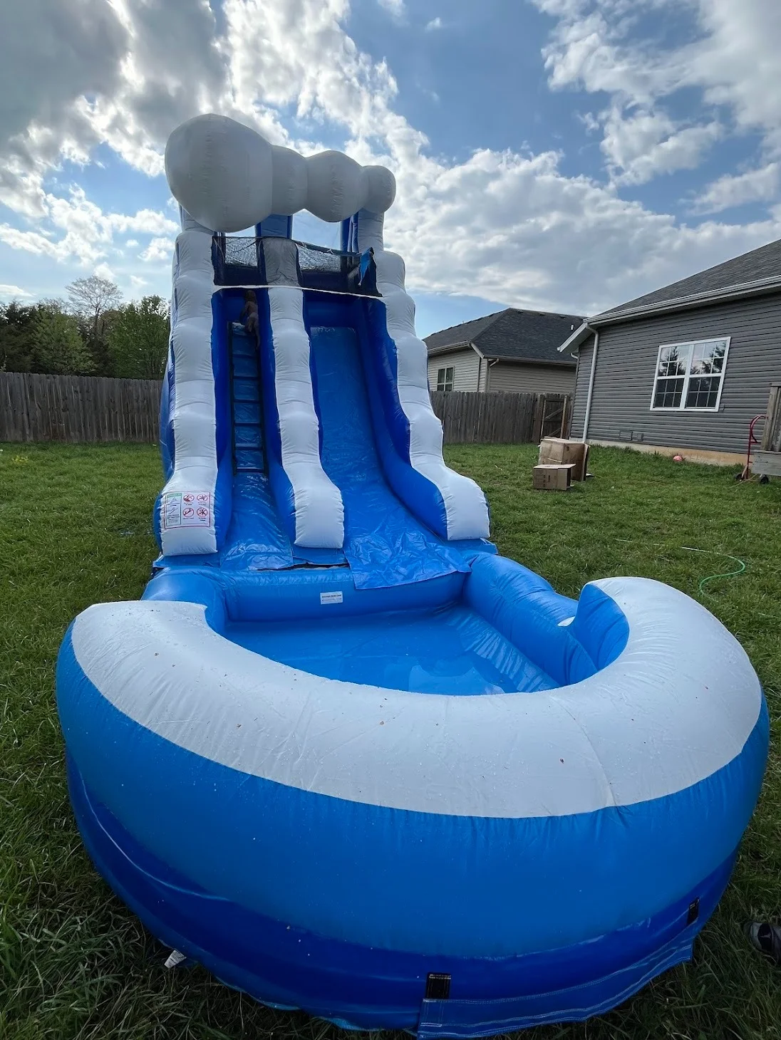 Blue Wave bounce house rental Springfield MO — front view in a backyard