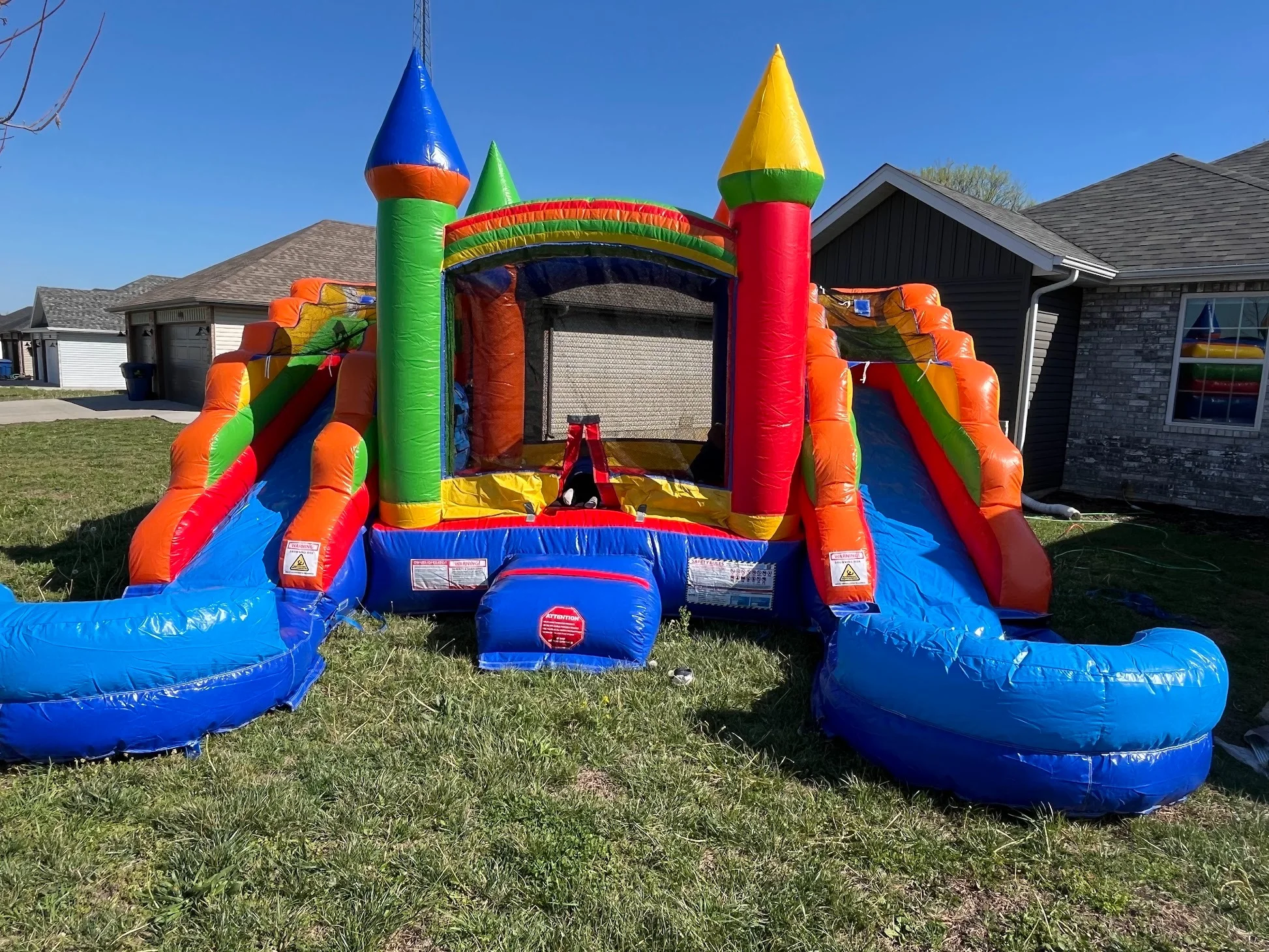 Combo slide and bounce house rental Springfield MO — inflatable on a lawn